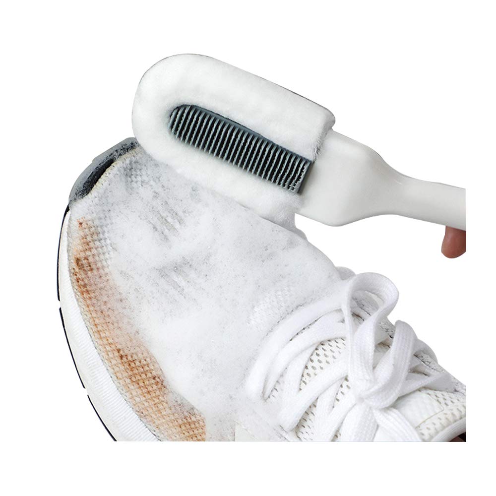 Professional shoe cleaning brush cleaning a stained white sneaker